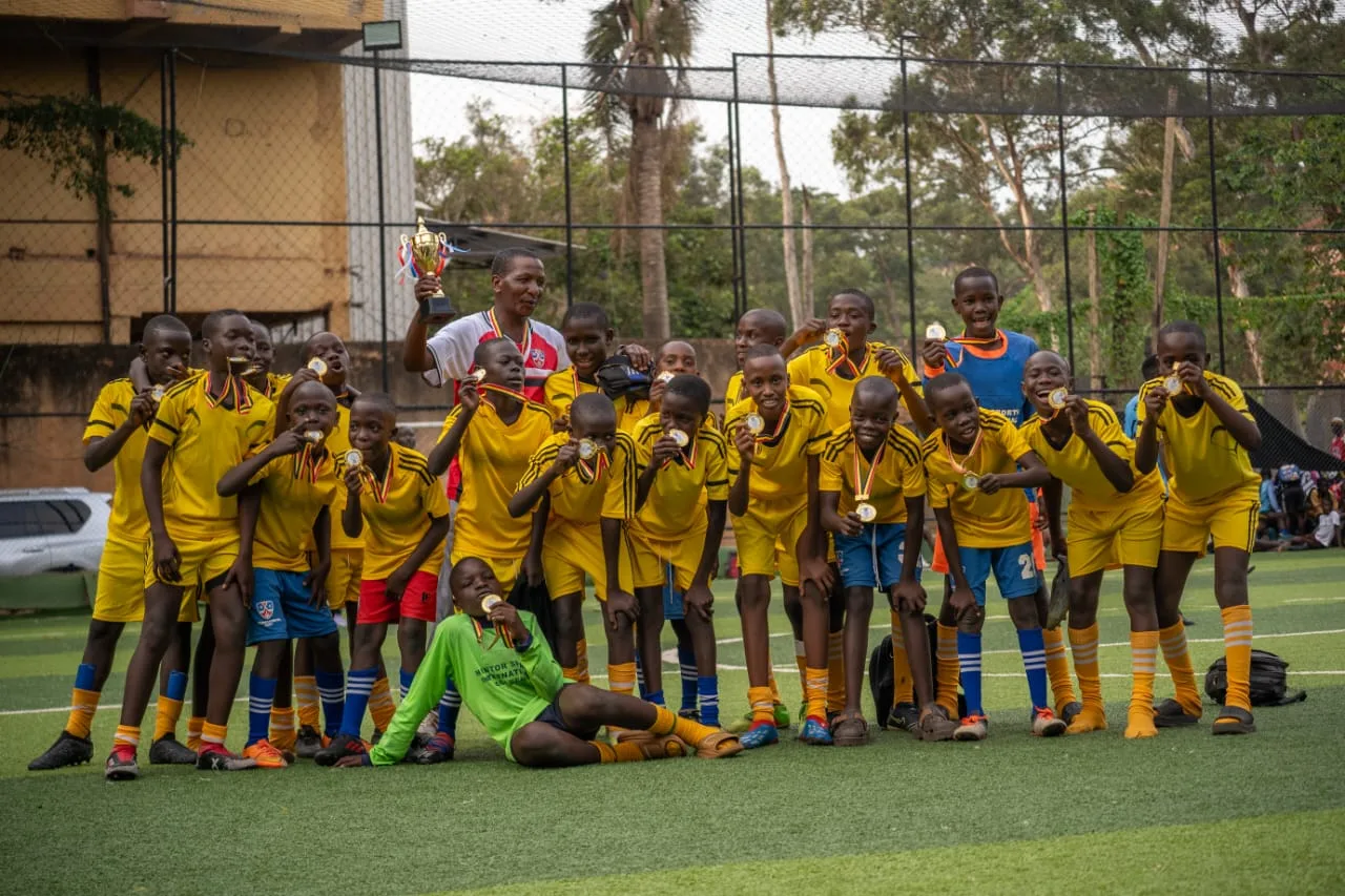 Yellow team celebrating with trophy and medals